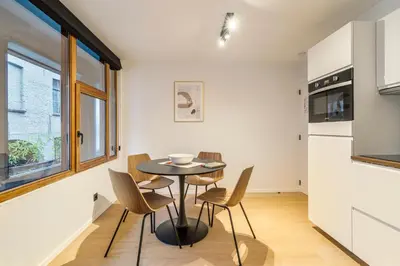 a kitchen and dining room with a table and chairs at Gezellig & Centraal - 4 Persoons Gentse Studio in Ghent