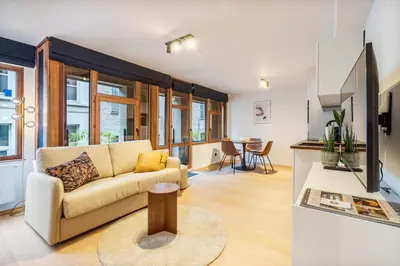 a living room with a couch and a table at Gezellig & Centraal - 4 Persoons Gentse Studio in Ghent