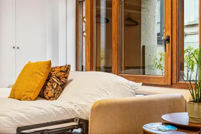 a bed with two pillows on it in a room at Gezellig & Centraal - 4 Persoons Gentse Studio in Ghent