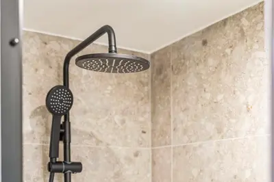 a shower with a shower head in a bathroom at Gezellig & Centraal - 4 Persoons Gentse Studio in Ghent