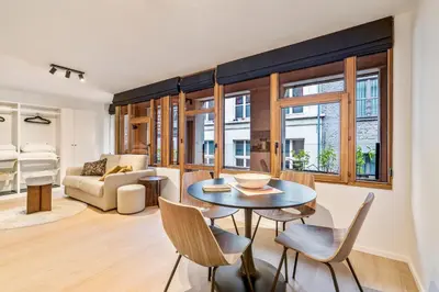 a living room with a table and chairs at Gezellig & Centraal - 4 Persoons Gentse Studio in Ghent