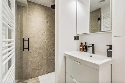 a bathroom with a sink and a shower at Charmante Studio op Toplocatie - Hartje Gent in Ghent