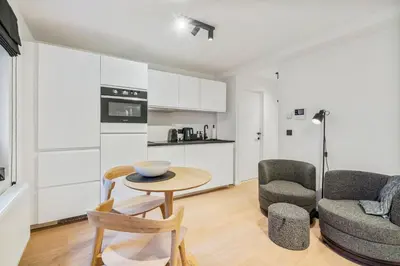 a living room with a table and two chairs at Gezellige Gentse Studio - Perfect Voor Koppels in Ghent