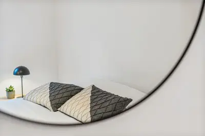a rendering of a bed in a mirror at Gezellige Gentse Studio - Perfect Voor Koppels in Ghent