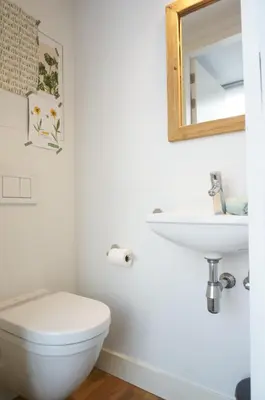 a bathroom with a white toilet and a sink at Charming duplex apartment with spectacular views in Antwerp