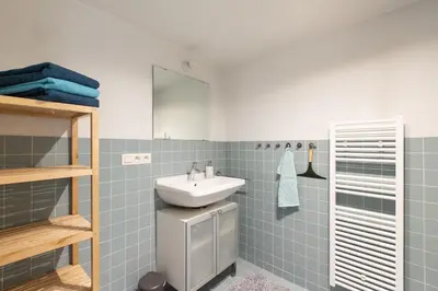 a bathroom with a sink and a mirror at Charming duplex apartment with spectacular views in Antwerp