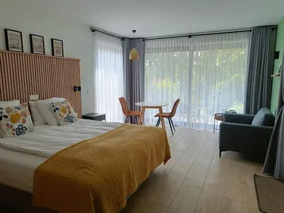 a bedroom with a bed and a table and chairs at het Boekenhof in Niel