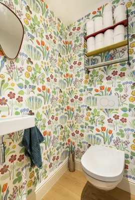 a bathroom with a toilet and floral wallpaper at Cozy Room with Garden in Brussels