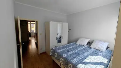 a bedroom with a bed and a door to a hallway at Suite Diamant - Chic & Lumineux in Brussels