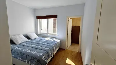 a small bedroom with a bed and a window at Suite Diamant - Chic & Lumineux in Brussels