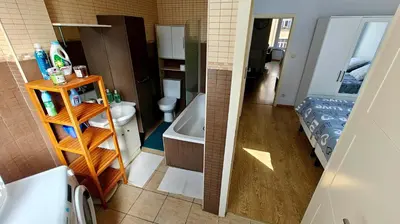 a bathroom with a tub and a toilet and a sink at Suite Diamant - Chic & Lumineux in Brussels