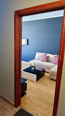 a living room with a couch and a mirror at Suite Diamant - Chic & Lumineux in Brussels