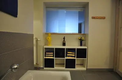 a bathroom with a sink and a mirror and a tub at Apartment Home Frit Home in Brussels