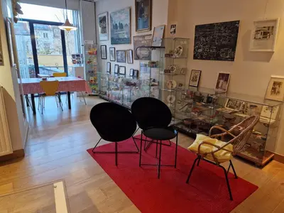 a room with two black chairs and a red rug at Apartment Home Frit Home in Brussels