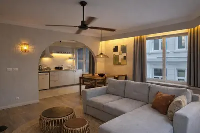 a living room with a couch and a kitchen at Japandi Lofts - 2 Bedrooms at old city of Antwerp in Antwerp