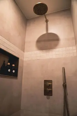 a bathroom with a shower with a spotlight on the wall at Japandi Lofts - 2 Bedrooms at old city of Antwerp in Antwerp