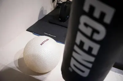 a white ball sitting on a desk next to a cup at The Haven in Sint-Genesius-Rode