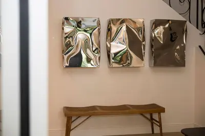 four paintings on a wall with a bench on a wall at The Haven in Sint-Genesius-Rode