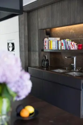 a kitchen with a sink and a counter with books at The Haven in Sint-Genesius-Rode