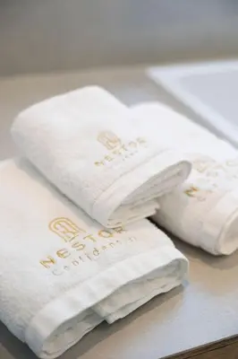 three white towels sitting on top of a counter at The Haven in Sint-Genesius-Rode