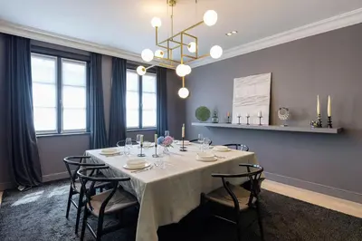 a dining room with a table with chairs and a chandelier at The Haven in Sint-Genesius-Rode