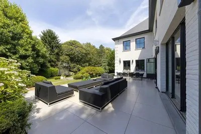 a patio with couches and chairs on a house at The Haven in Sint-Genesius-Rode
