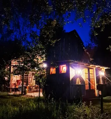 a small house with lights on it at night at Strackxhoeve Yurt 'Haardpeer' in Laakdal