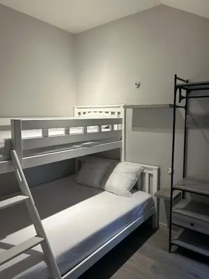 a bedroom with two bunk beds and a ladder at Comfortabele groepswoning voor 8 met ruimte tuin in Turnhout