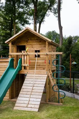 a wooden play structure with a slide and a playground at Comfortabele groepswoning voor 8 met ruimte tuin in Turnhout