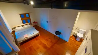 an overhead view of a bedroom with a bed and a toilet at Dolfijn Hostel in Antwerp