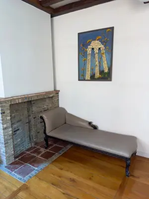a couch sitting in a room with a fireplace at Dolfijn Hostel in Antwerp