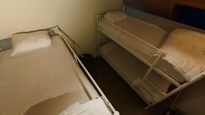 two bunk beds in a small room withthritisthritisthritisthritisthritisthritisthritisthritis at Dolfijn Hostel in Antwerp