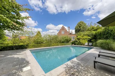 a swimming pool in front of a house at The Castle in Brussels