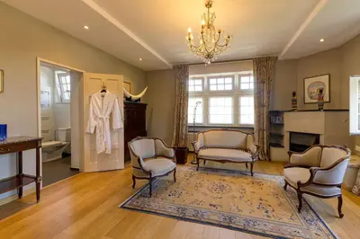 a living room with chairs and a mannequin in it at The Castle in Brussels