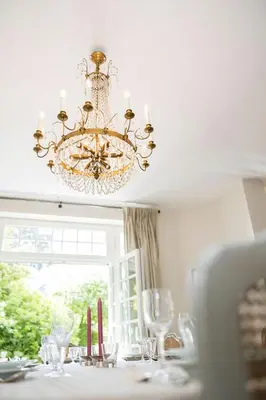 a chandelier hanging over a table with a window at The Castle in Brussels