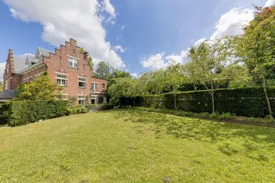 a large yard in front of a brick house at The Castle in Brussels