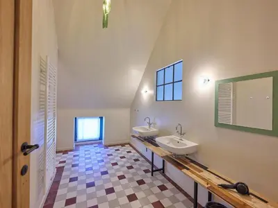 a bathroom with two sinks and a mirror at Lactea in Schilde