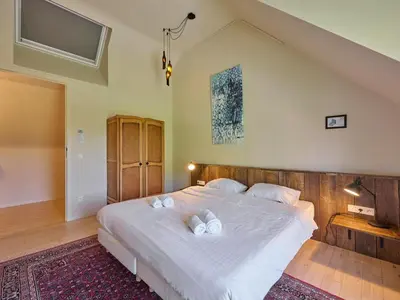 a bedroom with a large white bed with two pillows at Lactea in Schilde