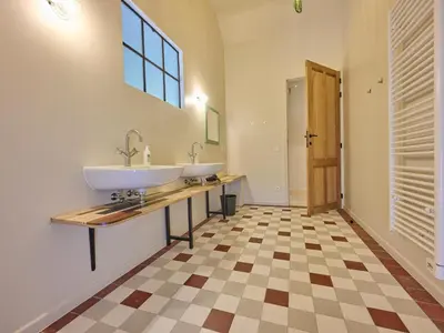 a bathroom with two sinks and a counter with a window at Lactea in Schilde