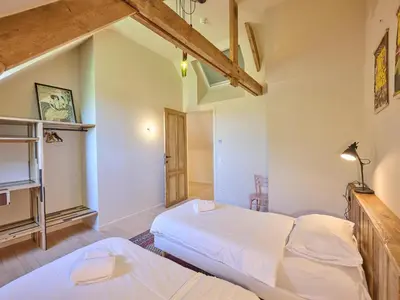 a bedroom with two beds and a tv at Lactea in Schilde