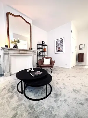 a room with a table and a chair and a mirror at Magnificent apartment in Sablon in Brussels