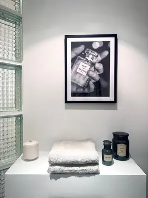 a picture hanging on a wall above a shelf with towels at Magnificent apartment in Sablon in Brussels