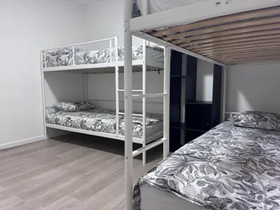 a bedroom with two bunk beds and a wooden floor at Breughel Apartments in Antwerp