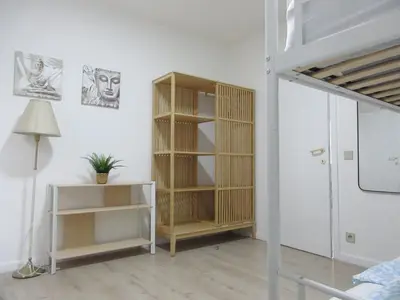a room with a book shelf and a lamp at Breughel Apartments in Antwerp