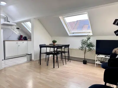 a living room with a table and some chairs at Breughel Apartments in Antwerp