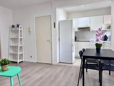 a living room with a dining table and a kitchen at Breughel Apartments in Antwerp