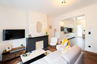 a living room with a couch and a fireplace at Family-Friendly 2-Bedroom Apartment in Antwerp in Antwerp