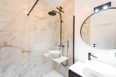 a bathroom with a shower and a sink and a mirror at Family-Friendly 2-Bedroom Apartment in Antwerp in Antwerp