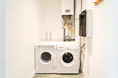 a laundry room with a washer and dryer at Family-Friendly 2-Bedroom Apartment in Antwerp in Antwerp