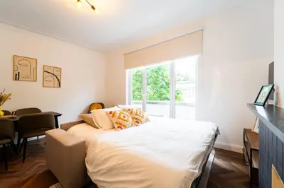 a bedroom with a large bed and a window at Family-Friendly 2-Bedroom Apartment in Antwerp in Antwerp